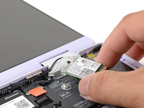 Carefully reposition the Wi-Fi card away from the Mainboard.