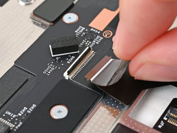 Use your fingers to grip the black pull tab and slide the Mid Plate Cable straight out of its socket.