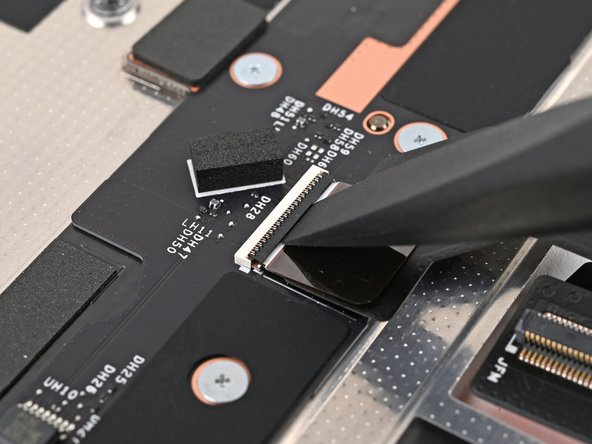 Use the flat end of the Framework Screwdriver, or a clean fingernail, to lift up the locking tab on the Mid Plate Cable ZIF connector.