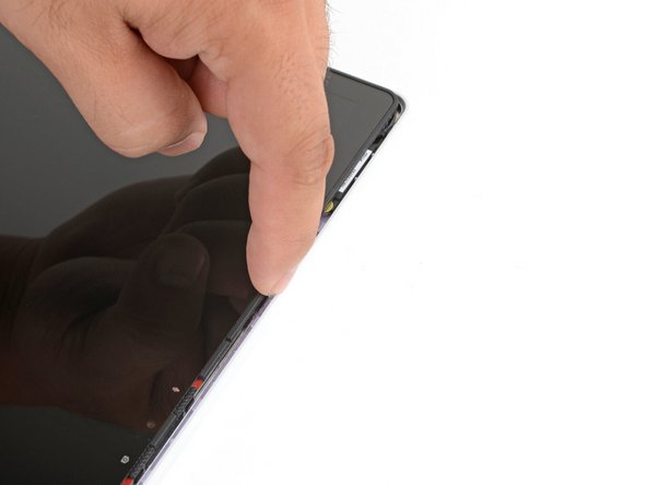 Use your fingers to lift the top edge of the display from the Top Cover.