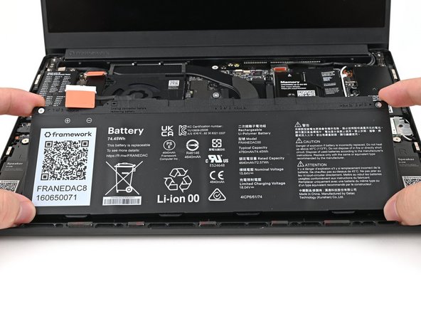 Insert the Battery into its cutout, making sure its plastic tabs are slotted into the Bottom Cover.