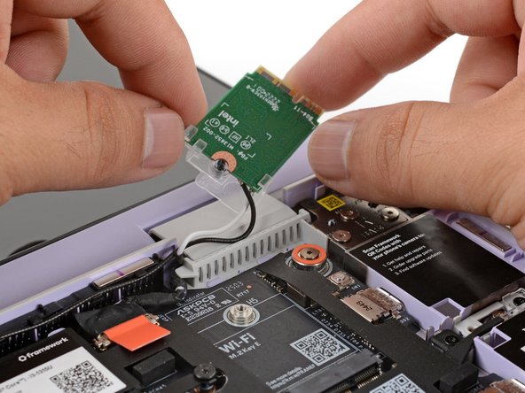 If the clear bracket or an antenna cable detaches from the Wi-Fi card, don't worry! You can reattach it during reassembly.