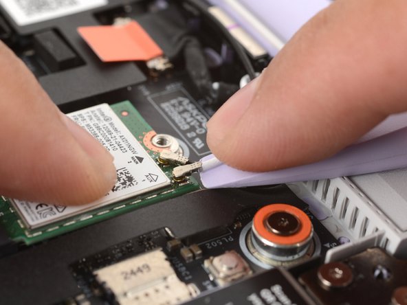 The Wi-Fi card has two delicate coaxial cable connectors. Follow this step carefully to avoid damaging them.