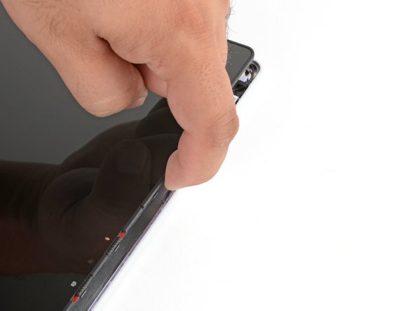 Use your fingers to lift the top edge of the display from the Top Cover.