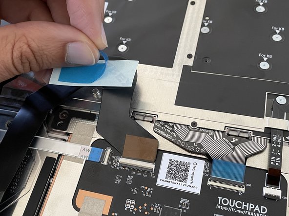 Peel the paper or plastic backing film off of the bottom side of the piece of double sided tape.