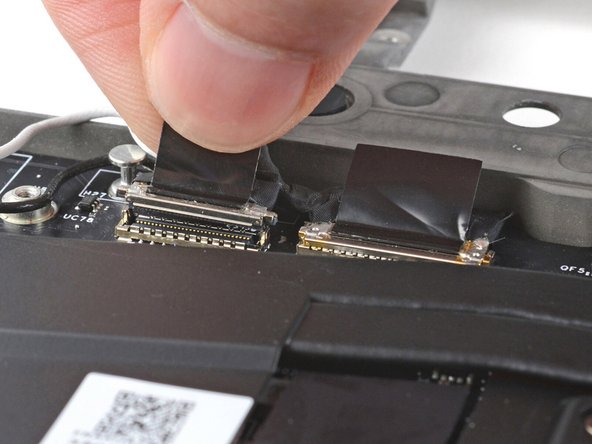 Repeat for the display cable connector next to it.