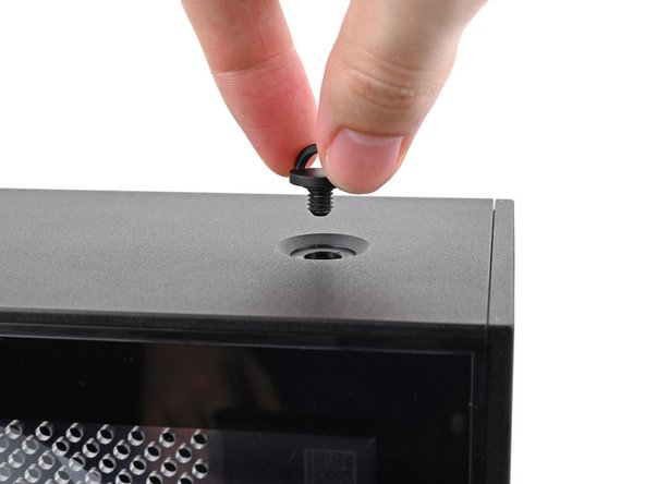 Insert the top panel screw into its hole and twist clockwise until it feels snug.