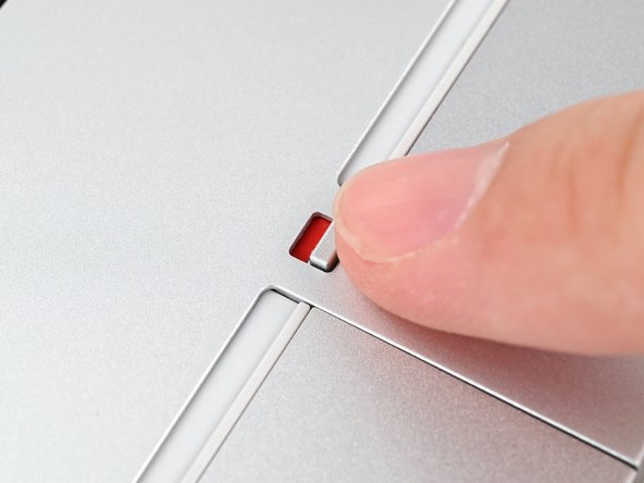 Use your finger to flip both latches and lock the rows of Expansion Cards.