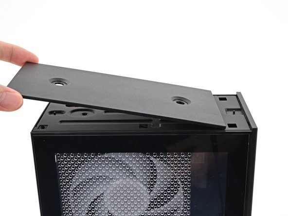 Orient the Top Panel so its arrow is pointing towards the rear of the computer.