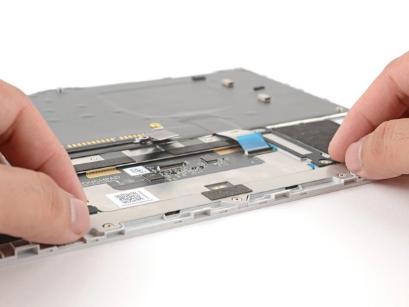 The tabs on the alignment tool will center the touchpad on the Input Cover.