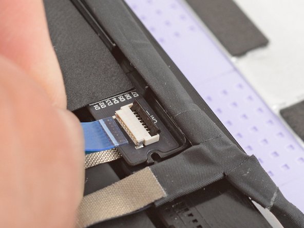 Use your fingers to grab the touch control cable by the blue tab and slide the cable out of the connector.