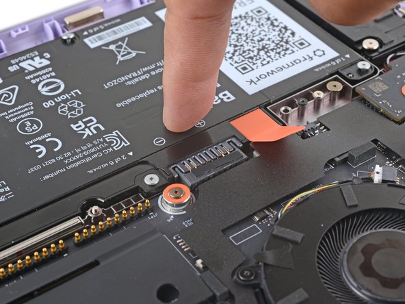 Use your finger to push the battery down near its connector to reconnect it.