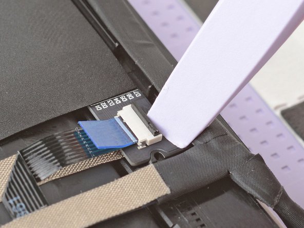 Use your fingers to grab the touch control cable by the blue tab and slide the cable out of the connector.