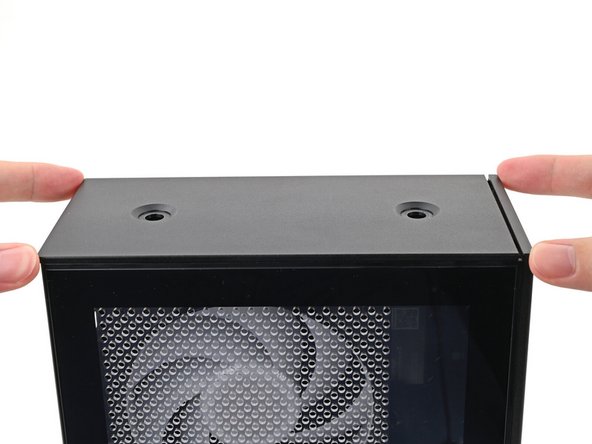 While securing the computer with one hand, use the other hand to slide the Top Panel towards the front of the computer to close the gap and engage the clips.