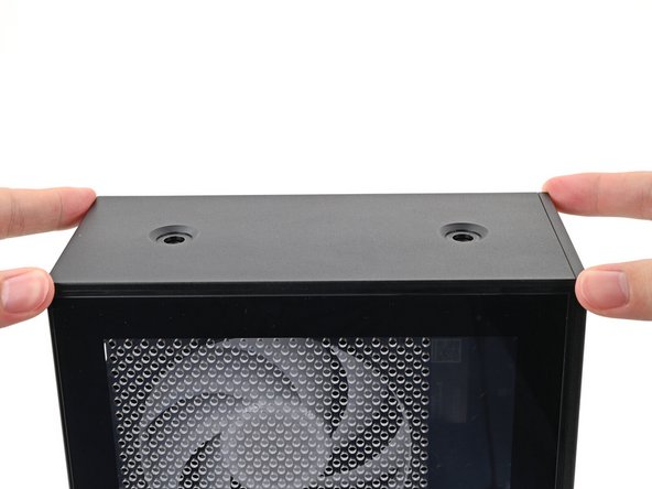 While securing the computer with one hand, use the other hand to slide the Top Panel towards the front of the computer to close the gap and engage the clips.