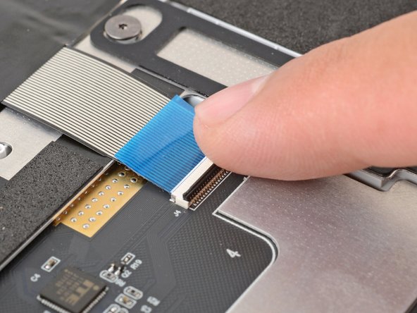 Use your finger to flip down and gently press the locking tab in place.