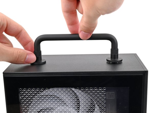 While holding the Handle in place, twist the screw threads on both sides clockwise until they're snug on the Top Panel.