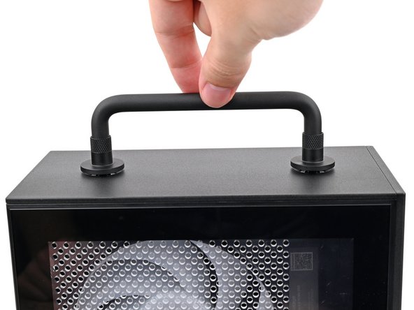 Place the Handle over the Top Panel screw holes.