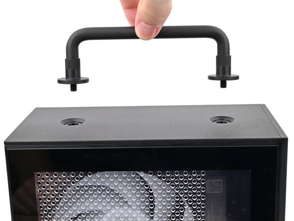 Place the Handle over the Top Panel screw holes.