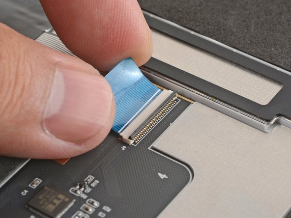 Slide the keyboard ZIF cable into its connector, up to the printed line on the cable.