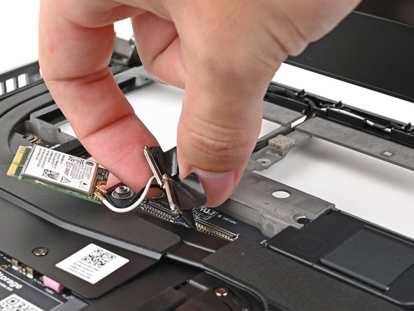 Route the display, webcam, and Wi-Fi module cables into their slots in the frame.