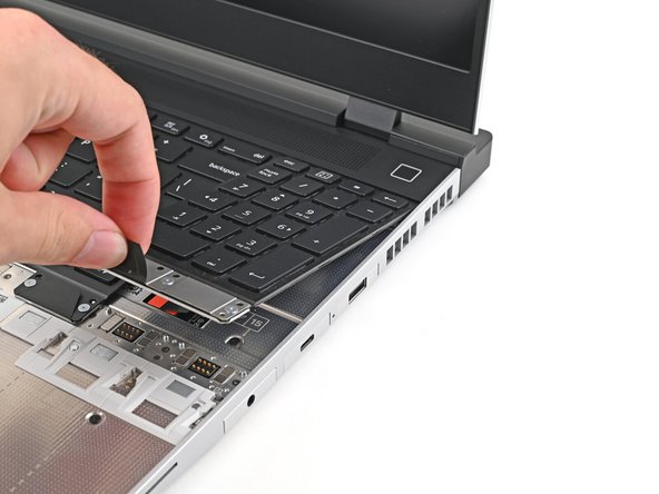 The numpad is held in place with strong magnets. Apply gradually increasing force to avoid having the Numpad violently eject.