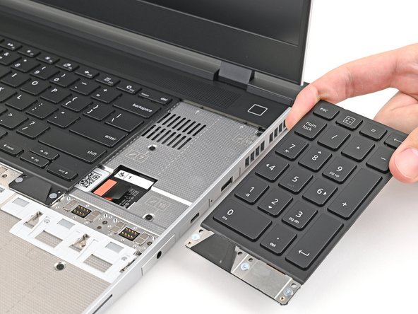 Grip the pull tab at the bottom of the Numpad.