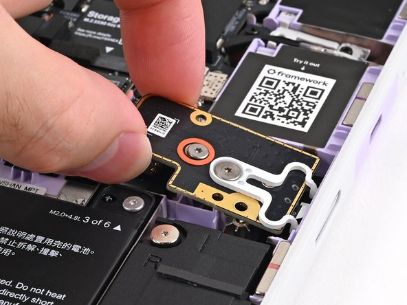 Use the two plastic pins on the laptop to align the Fingerprint Reader.