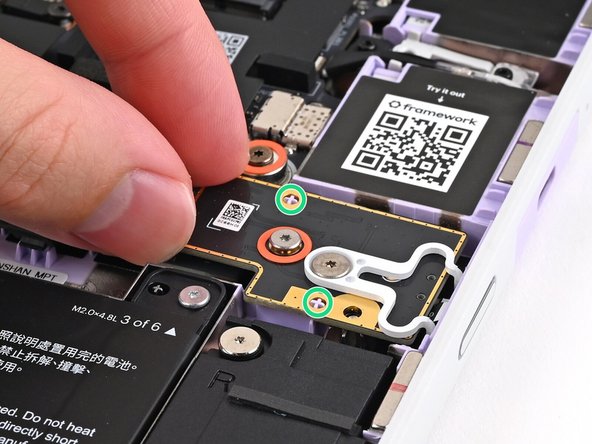 Use the two plastic pins on the laptop to align the Fingerprint Reader.