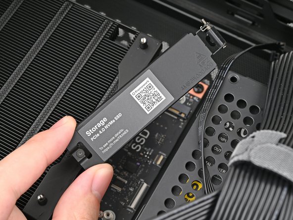 Lift the primary storage heat spreader out of the desktop and remove it.