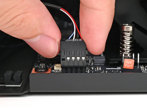 Use your fingers to lift the power button cable connector off its nine‑pronged socket on the Mainboard.