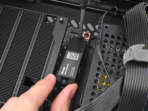 If your SSD comes with a pre-installed heat spreader, follow the next two steps. Otherwise skip to Step 15.