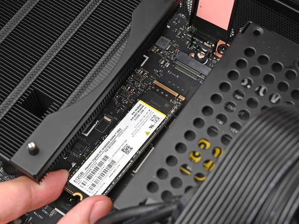 Hold the SSD by its edges. Don't touch the gold contacts with your fingers. If you do, wipe the contacts with a clean, lint-free cloth to remove any finger oils.