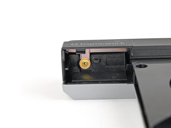Two screws on the flat surface of the module, next to the fans.