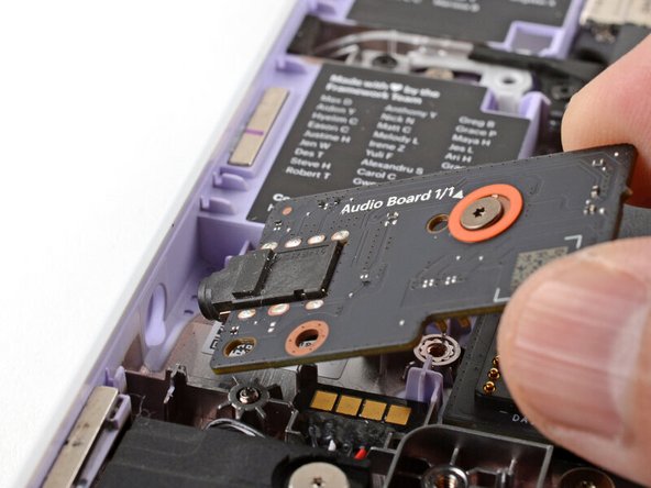 Insert the Audio Board into the laptop at an angle to help align the headphone jack.