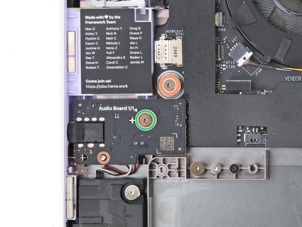 Use your Framework Screwdriver to loosen the captive T5 Torx screw securing the Audio Board, located near the left edge of the laptop.