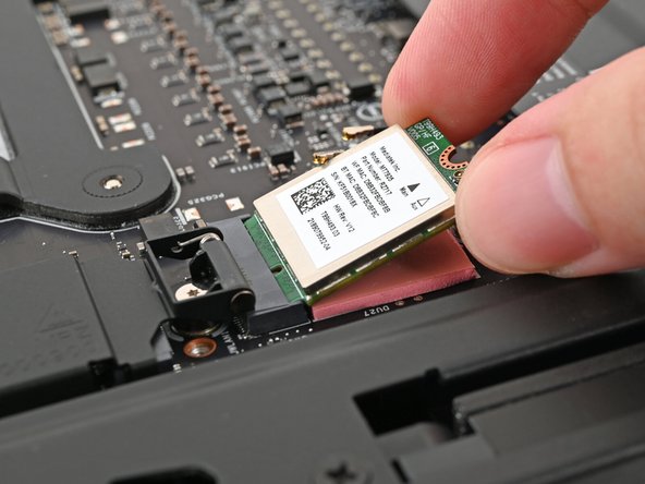 Align the Wi-Fi module's gold contacts and notch with the socket on the Mainboard.