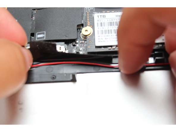 Peel the black tape back and place the wires under it. Cover the wires with same tape.