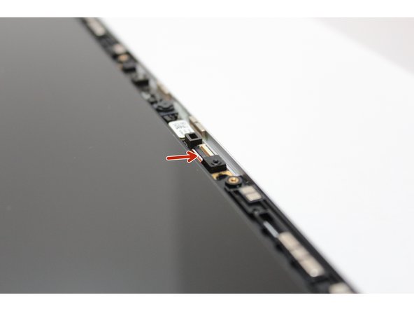 Using your fingernail or the spudger side of the Framework Screwdriver, flip up the black latch on the Webcam Cable to disconnect it.
