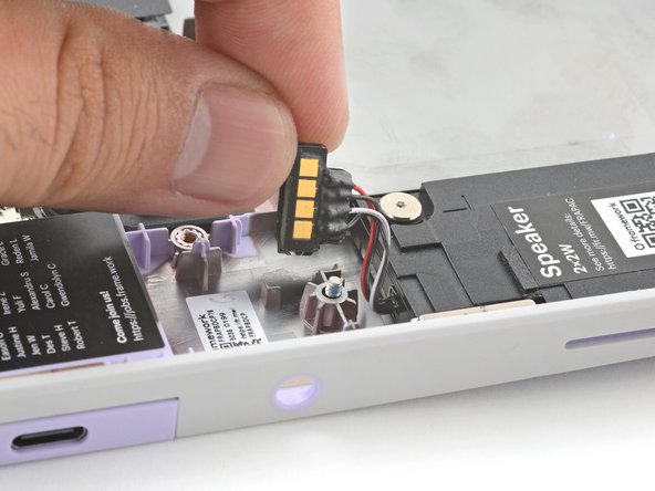 Use the flat end of your Framework Screwdriver to pry up the speaker connector from its recess near the top of the left speaker.