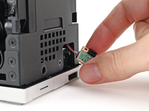 Grip the cable from the top of the Desktop and thread it through the chassis.