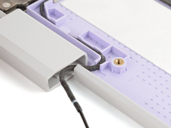 Make sure both antenna cables are properly routed in the Top Cover and tucked into the hinges, as shown in the images.