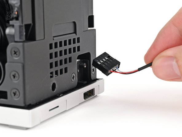Insert the Power Button Board cable into the slot in the Desktop.