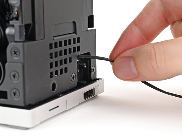 Grip the cable from the top of the Desktop and thread it through the chassis.