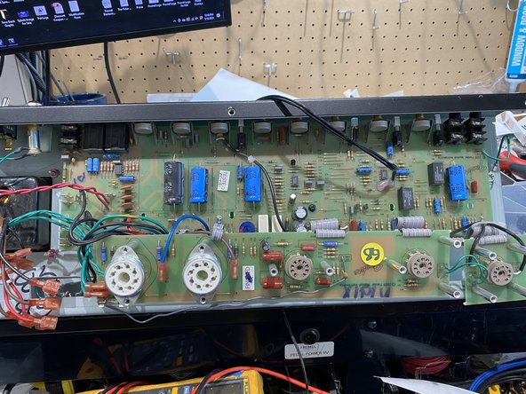Pull gently on the PCB to make sure that it's not stuck to any of the standoffs where screws had been holding it