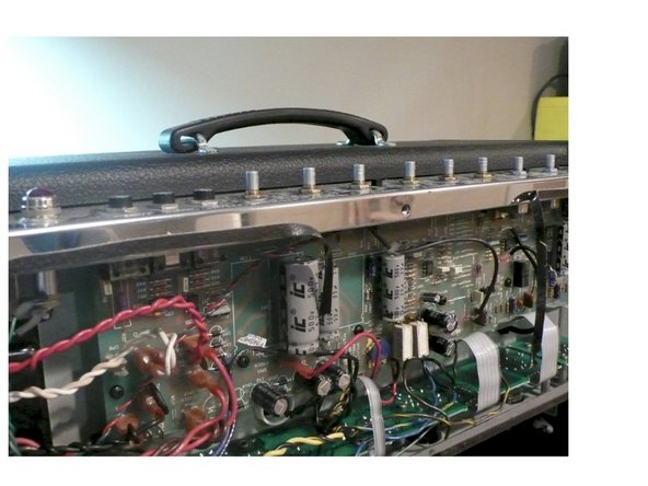 Carefully put the PCB back into place making sure that the pots, switches, and input jack all line up with the control panel and replace all the PCB mounting screws