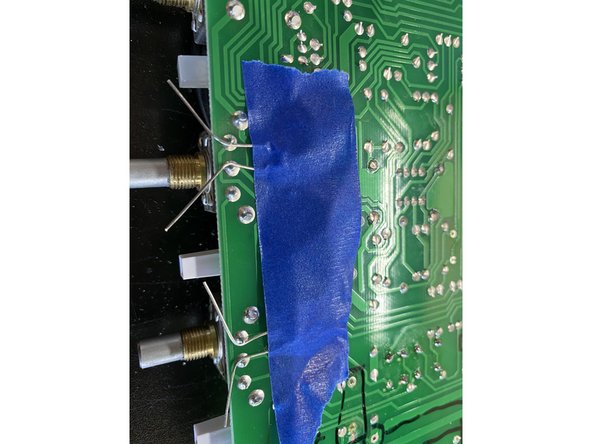 Pro  tip: Use low  tack painters tape to hold the 100pf caps in place while you  solder!