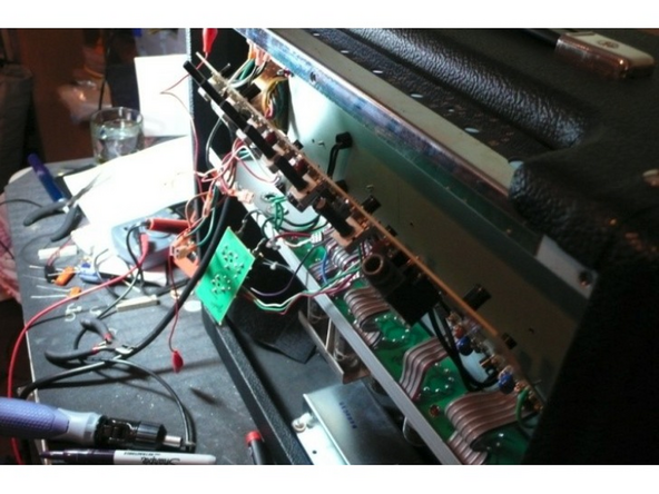 Pull gently on the PCB to make sure that it's not stuck to any of the standoffs where screws had been holding it