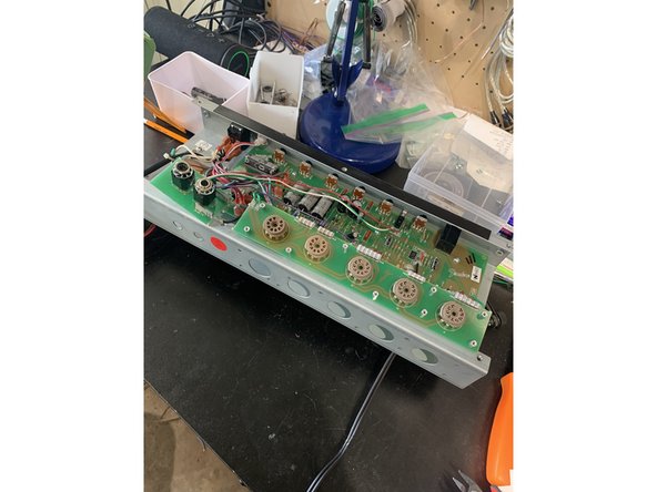 Gently, with putting as little strain and  lateral motion on  the  ribbon  cable, lift the tube  board  and footswitch/  speaker jack assembly up and free of the chassis