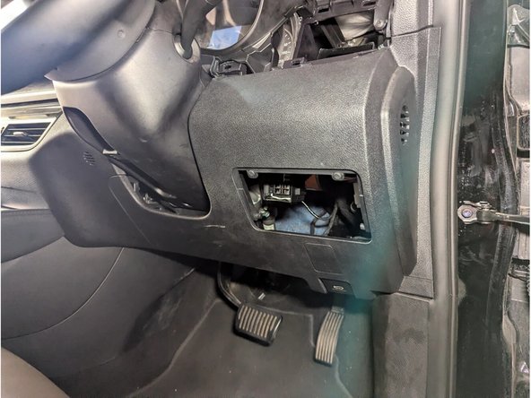 Remove the change box. Unclip the driver-side front panel held by plastic clips. Unplug the 4-pin green connector to completely remove it.